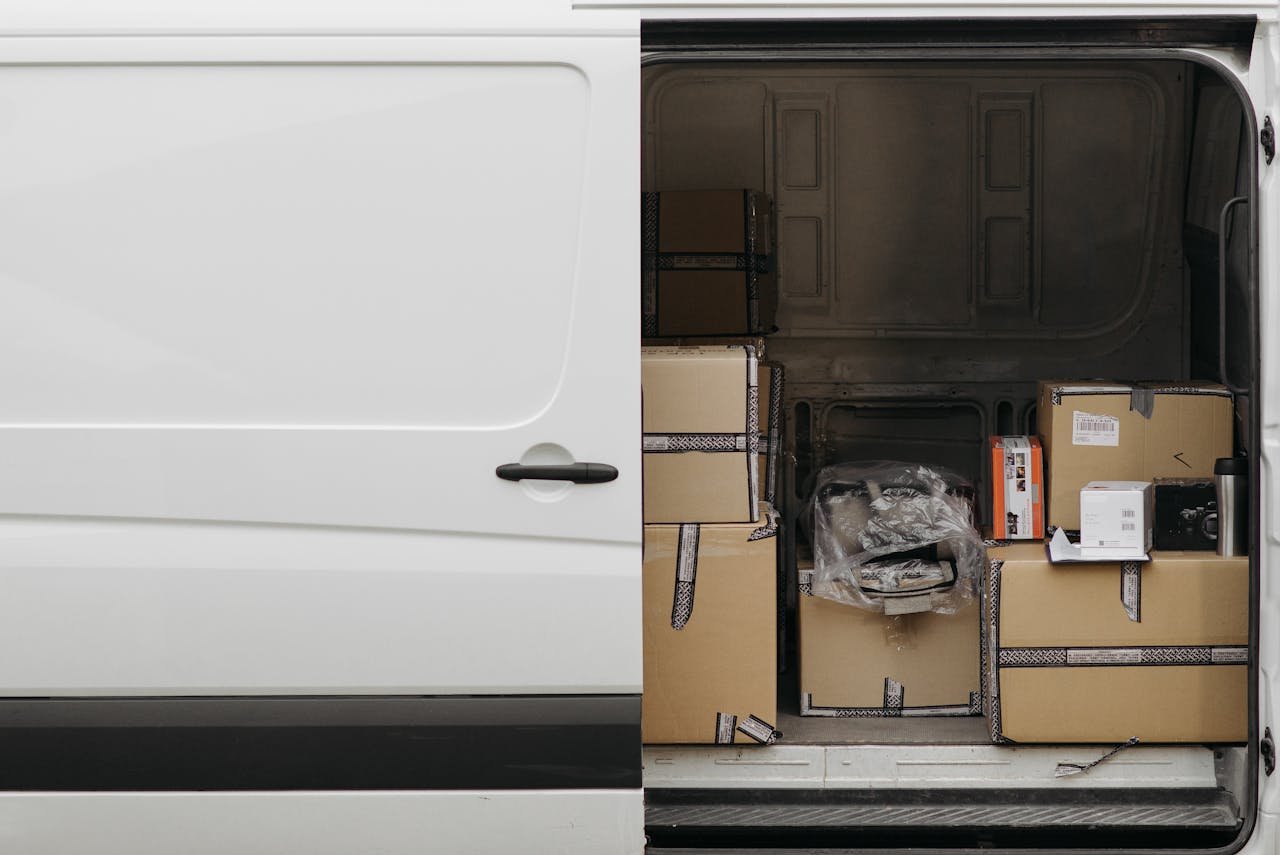 Servicios Open delivery van filled with boxes, ready for logistics and transport services.